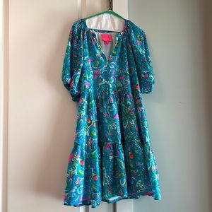 Lilly dress with shirred waist and bottom ruffle. Fully lined. 100% polyester.